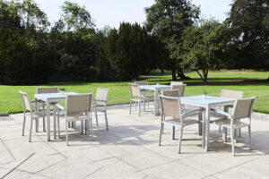 Patio area outside with tables and chairs