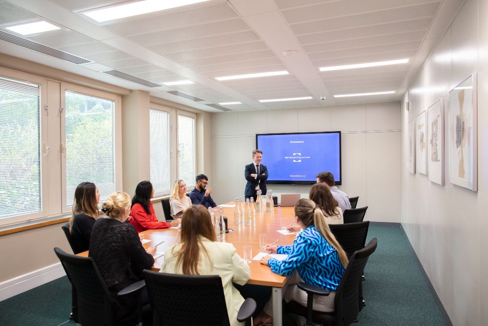 meeting room at Kents Hill Park with people sat around a boardroom table